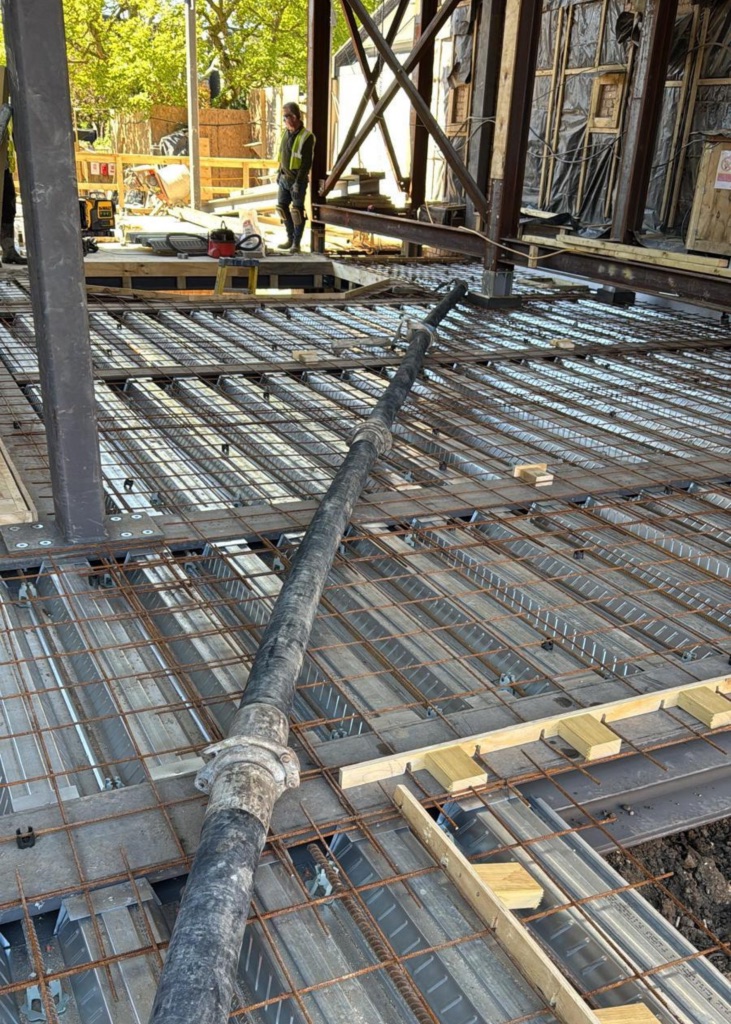 A King Concrete Pumping line pump feeding concrete on site near Epsom
